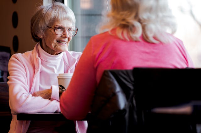 residents sat with a hot drink