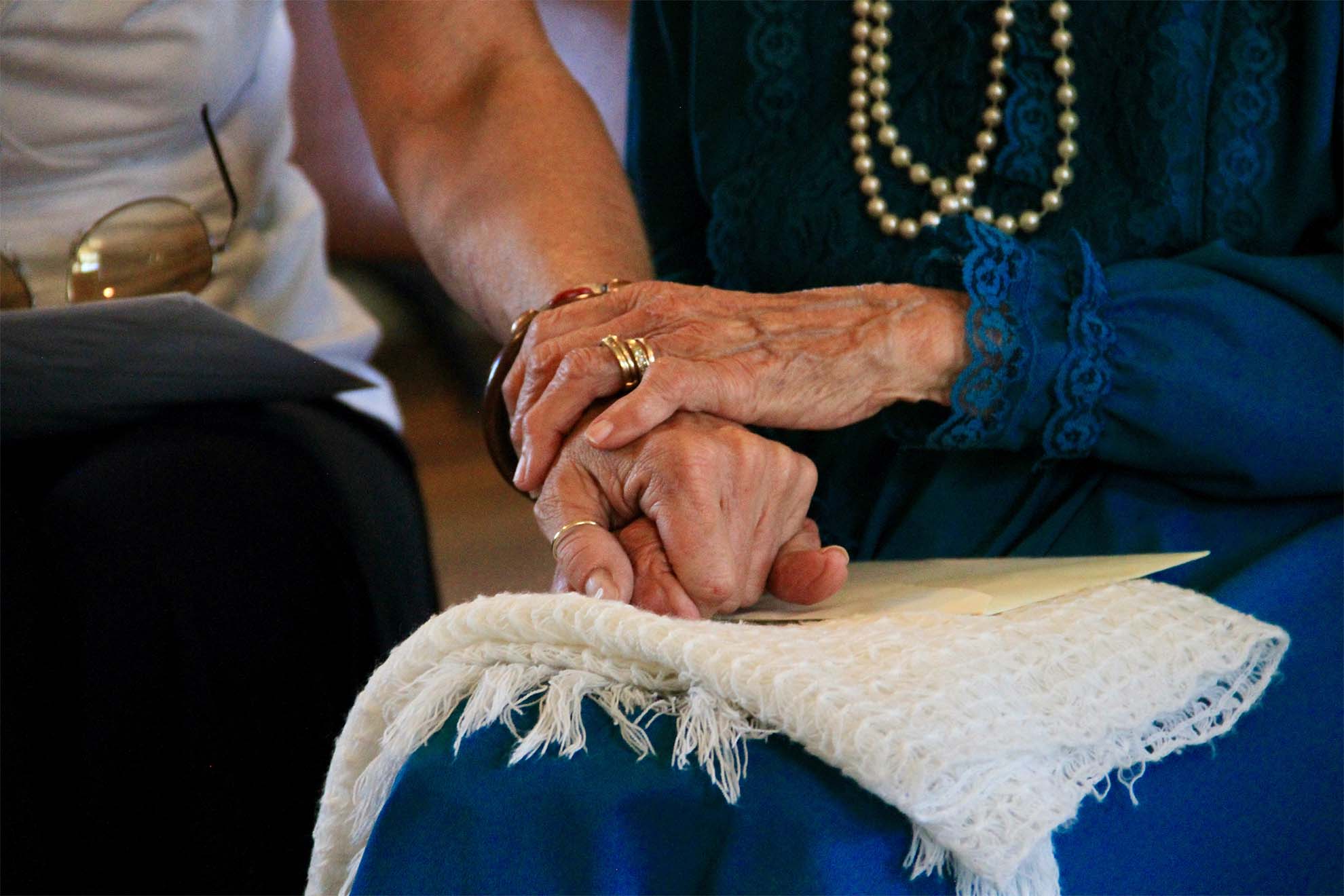 resident holding loved ones hand
