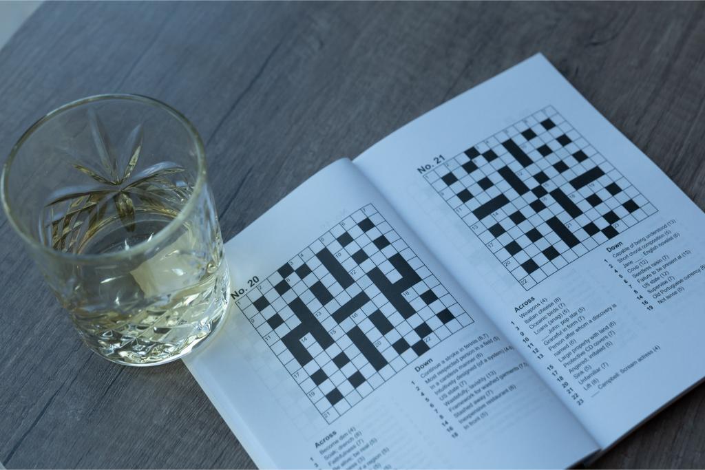 crossword and glass of whisky
