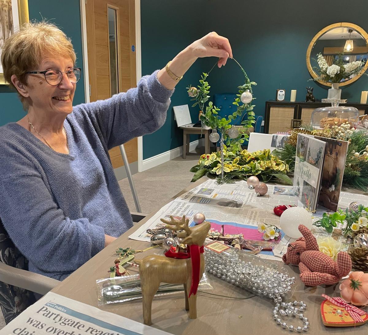 resident making christmas wreath