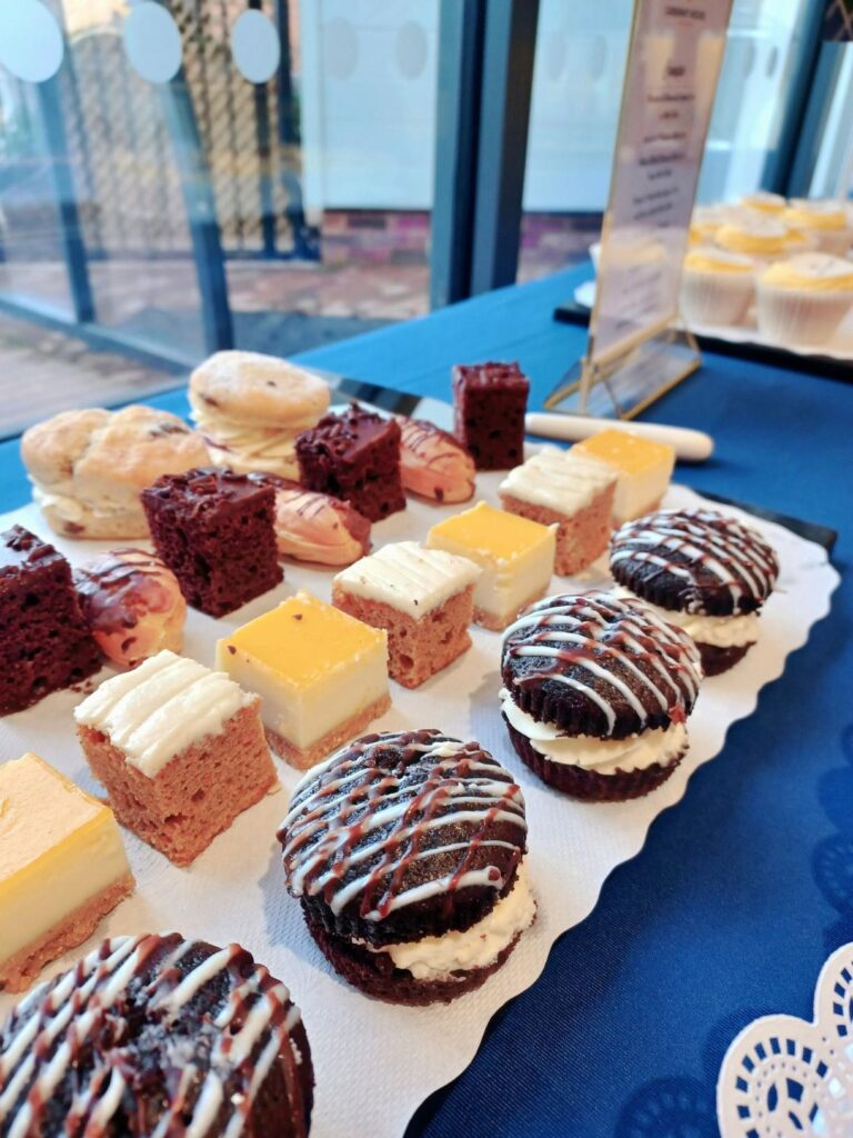 a variety of cakes on a table for our open day