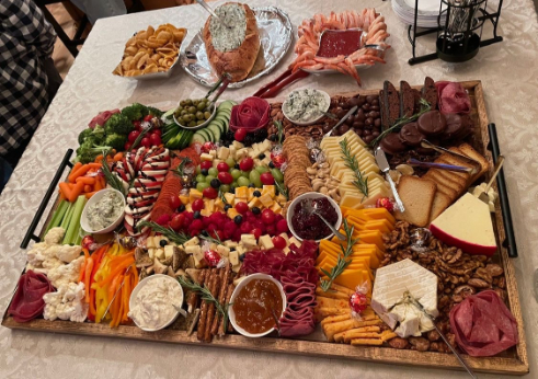 platter full of meat, cheese, fruit and crackers