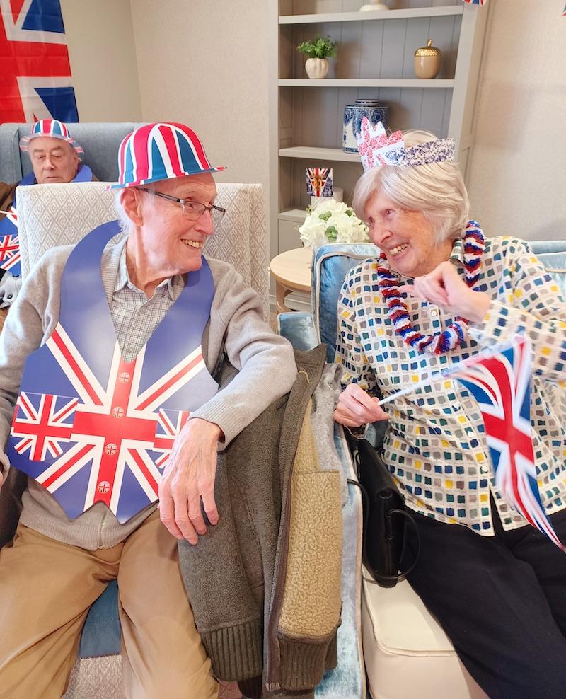 two of our residents sat with VE accessories on smiling