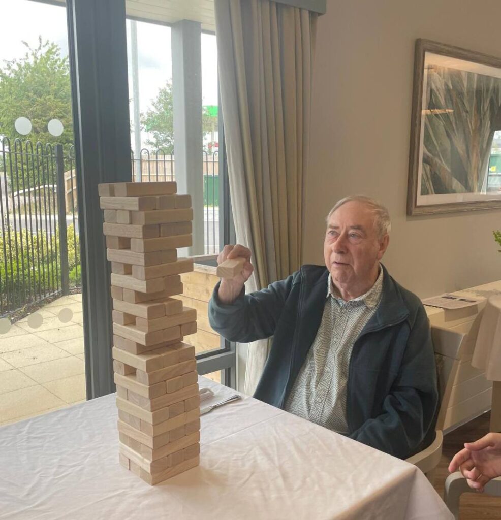 one of our male residents sat down playing giant jenga