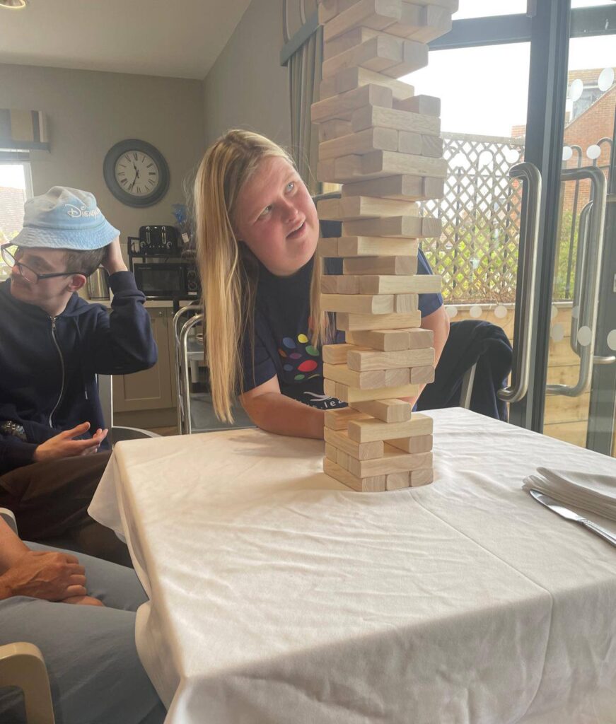 one of our volunteers playing jenga with residents