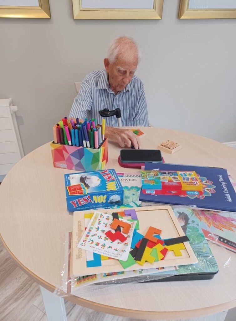 resident sat enjoying activities at the table