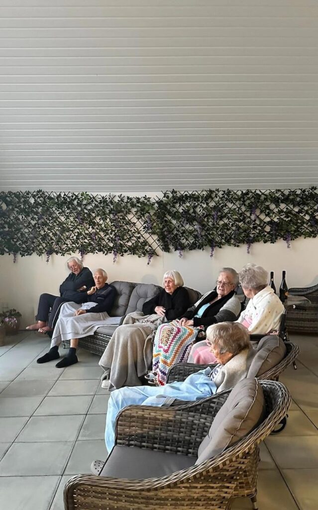 residents sat on our balcony with blankets