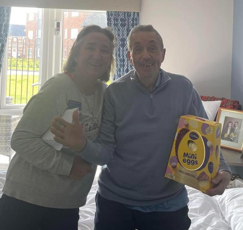 residents with easter eggs smiling