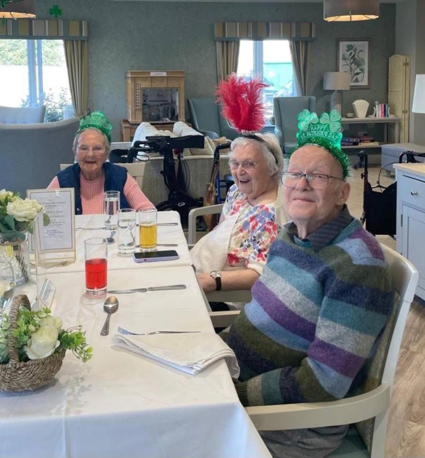 residents at a table on st Patrick day celebrating